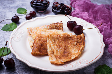 Pancakes with cherry jam and berries