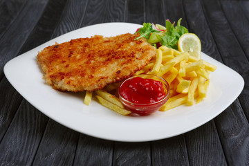 Fried chop pork cutlet with potato and ketchup