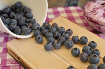 Cup of blueberries overturned