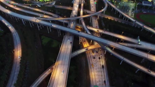 Aerial view of urban highway system at night.