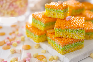 Cubes of delicious rice treats and sweets on light table