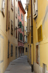 Fototapeta na wymiar narrow Italian street with a yellow three-storey houses