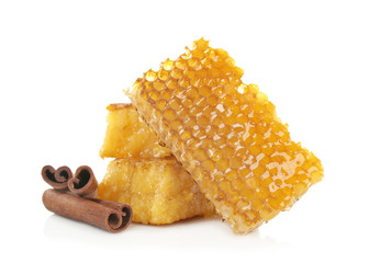 Honeycombs and cinnamon on white background