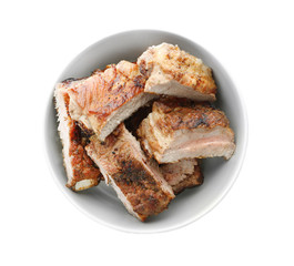 Juicy fried spare ribs in bowl, isolated on white, top view
