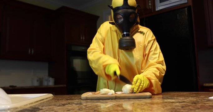 Woman in Haz Mat chopping onions