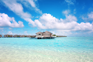 Modern beach houses on piles at tropical resort