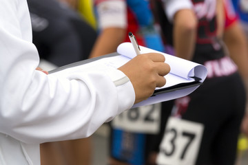 sport  referee checks the numbers of the competitors