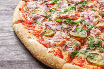 Delicious pizza with arugula and ham