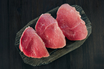 Raw pork meat on cutting board. Top view