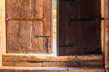 An old semi-open wooden door