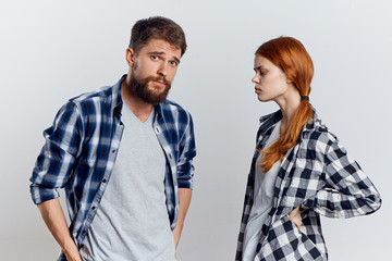 Beautiful young woman and man with a beard on a light background, repair, construction tools