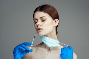 Beautiful young woman on a black background, doctor, medicine