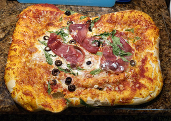 Hot, out of the oven homemade pizza! Irregular shape.