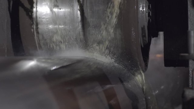 Rolling forming rolls metal works on manufacture of pipes. Rolling mill machine for rolling steel sheet. Rolling mill machine with cooling water close up