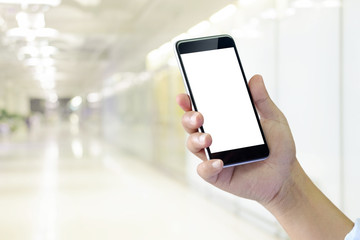 Man's hand using cellphone, Man typing text message on smart phone blurred city background