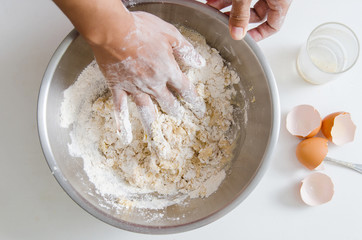 Bread cooking,hand mixing yeast,egg yolk,sugar and flour in a bowl