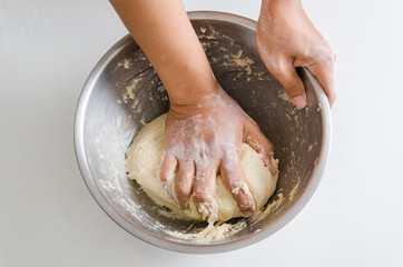 Bread cooking,kneading bread dough in a bowl by hand