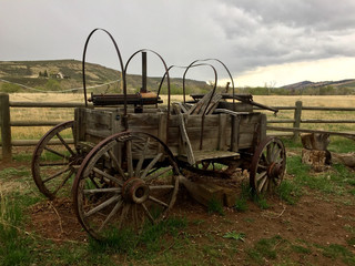 Vintage antique covered wagon in American prairie grassland
