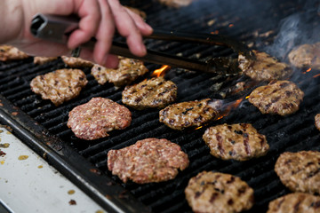 BBQ outdoors meat on the grill cooking burgers patties delicious