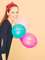 Fototapeta premium Smiling crazy girl having fun with balloons.