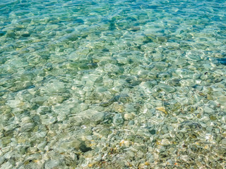 Fototapeta na wymiar Crystal sea water with a rocky bottom