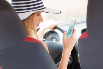 Woman using phone while driving her car