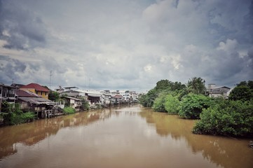 riverside community with cloudy blue sky in Thailand