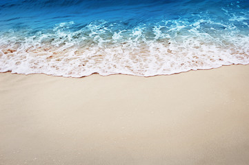 Fototapeta na wymiar light wave of the sea on the sandy beach