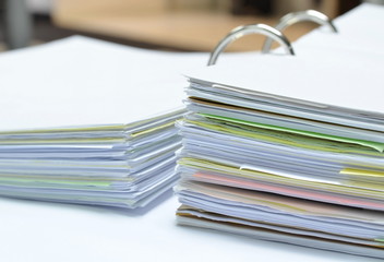 Pile of papers and business documents on white table at workplace,business concept,office supplies.