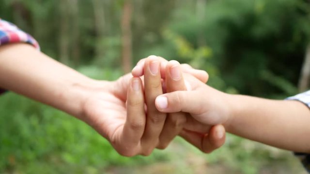Close up hands mother with son.