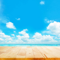 Wood table top on blue sea & sky background