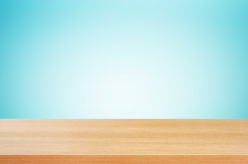 Wood table top on gradient white & blue background