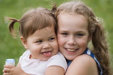 A two banies sisters playing in park, outdoor walking