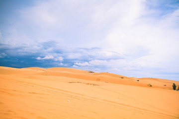 Fototapeta na wymiar White Desert At Mui Ne / Sunny Day With Blue Sky And Clouds On Sand Dune (White Desert) At Mui Ne Vietnam.