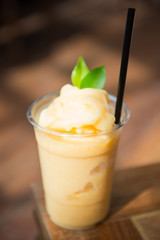 Sweet mango smoothie in plastic cup