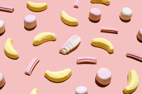 Assorted candy on pink background, studio shot