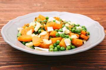 Warm salad with roasted pumpkin, peas and cheese brie