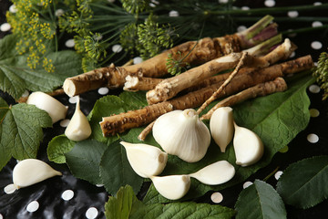 Ingredients for marinade: garlic, horseradish, dill, leaves. Ingredients used for vegetables preservation.