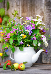 Autumn bouquet of wild flowers and apples
