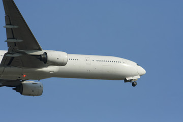 Fototapeta na wymiar Close Up shot of Airplane Take off in Blue sky