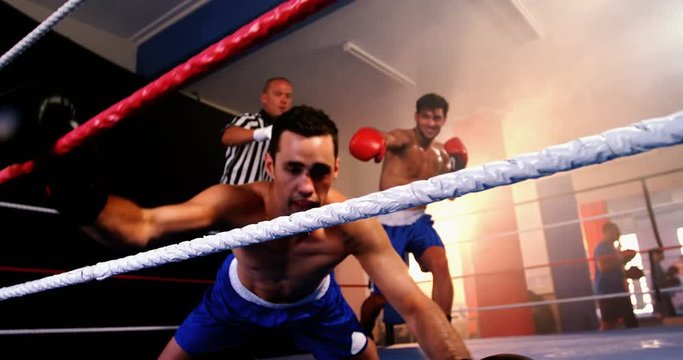 Two boxers fighting in boxing ring