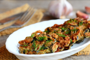 Eggplant burgers with greens and garlic on a white plate. Simple and quick eggplant recipe. Vegetable burgers idea. Closeup