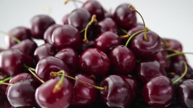 Heap of fresh cherries rotate on white background. (4K, HD, high definition 1080p). Healthy food concept.