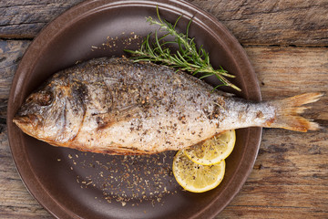 Seafood eating. Grilled fish on plate from above.