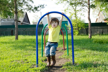 little girl playing outdoors. Kid on playground, children activity. Child having fun. Active healthy childhood concept