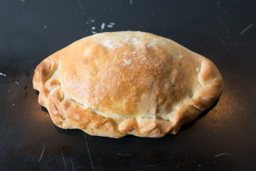 Baked pasty hot out of the oven on a baking tray