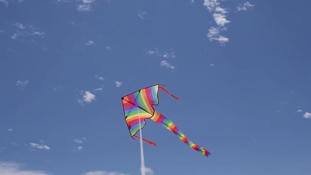 flying delta kite with nice clouds and deep blue sky