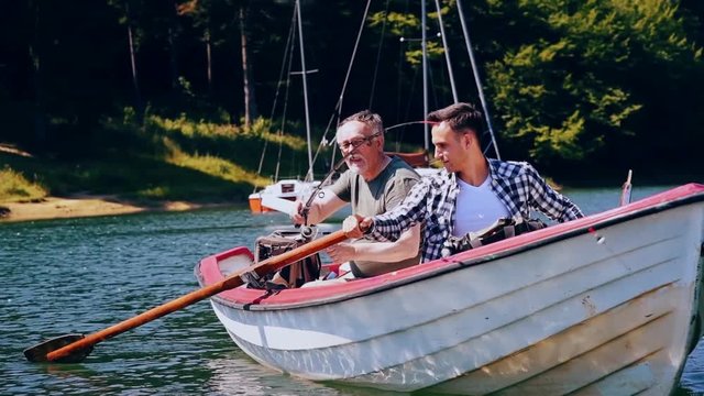 Two fishermen fishing in boat