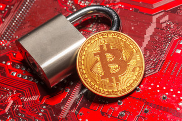 Gold bitcoin and padlock