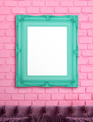 Blank green vintage victorian style picture frame hanging on pink brick wall over luxury purple...